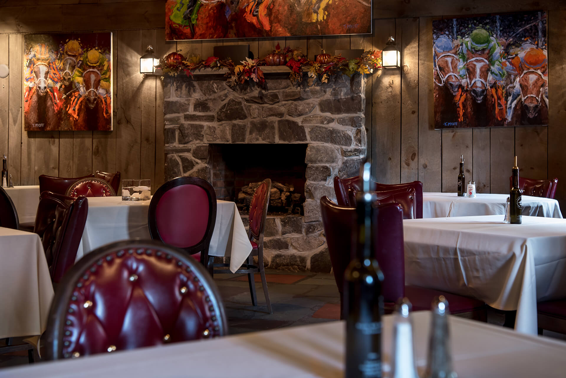 Large restaurant dining room with a stone fireplace.