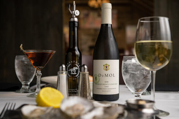 Bottle of wine, martini and wine glass on a table with a white cloth.